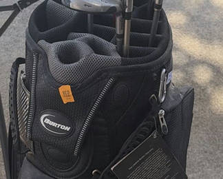 Lot 30: Burton golf bag with multiple golf clubs