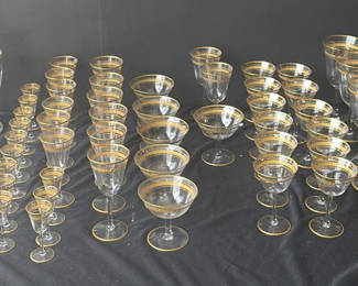 Lot 58: Gold-rimmed glassware set with punch bowl and stemware