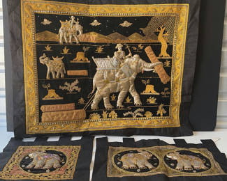 Lot 81: Embroidered black fabric wall hangings with gold elephant motifs