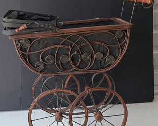 Lot 86: Antique wrought-iron baby carriage with decorative scrollwork