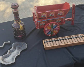 Lot 17: Assorted vintage decorative items: painted wooden wagon, abacus, bottle, dish, and crank