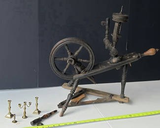 Lot 84: Antique spinning wheel with brass candlesticks and hand tools
