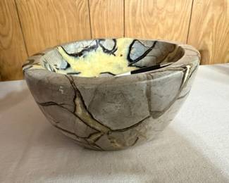 The gray/tan areas are limestone. The dark brown lines are Aragonite. The yellow/ honey colored areas are Calcite Crystals.