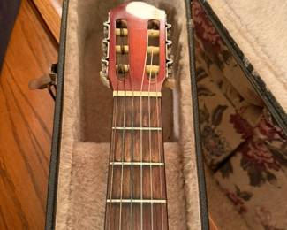 Showing the bridge pins and frets of the guitar