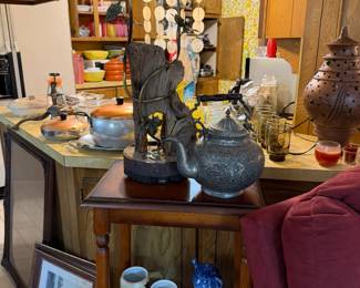 Accent table with shelves, beer mugs, metal teapot, driftwood lamp with two lights