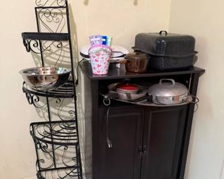 Media storage cupboard with electrical hook ups, vintage pans, iron corner piece with glass shelves