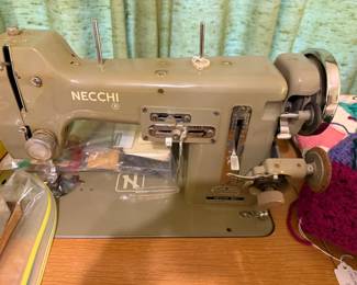 A close look at the Necchi Sewing machine with instruction book and accessories