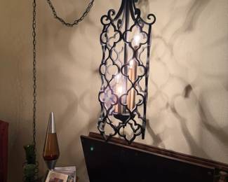 MC Spanish Revival iron swag light with a three way switch giving you three combinations of the four light bulbs.