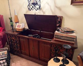 Mid-Century (MC) Silverton console stereo with turntable, radio and record storage. Great fretwork on the front panels, in working condition.