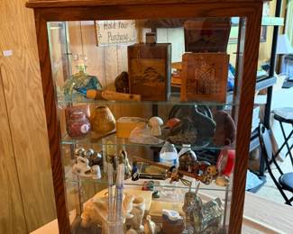 This showcase contains, vintage boxes, ceramics, Alabasta pieces, pocket knives, and lots of vintage travel pieces