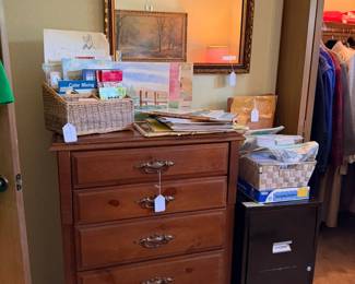 A closer look at the chest of drawers, lots of office supplies, vintage maps, art work