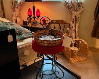 Vintage vanity stool with metal scrollwork and velvet seat, basket contains vintage earrings