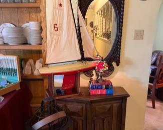 This is the entrance hall, vintage carved mirror, sail boart, small Tiffany style accent lamp