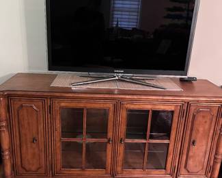 Samsung TV and Wood entertainment cabinet