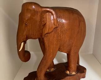 We have a large and small carved wooden elephants