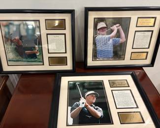 Framed pictures with plaques of Tiger Woods, Phil Mickelson, and Lee Janzen