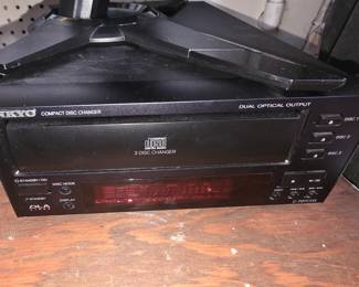 This is an Onkyo C-707CHX compact disc changer featuring a black metal chassis and a 3-disc carousel system.