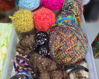vibrant collection of art yarn and textured novelty yarn in various colors and metallic finishes.