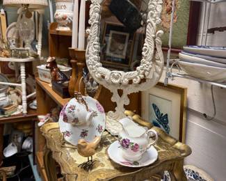 metal standing mirror, table, tea cup & saucer