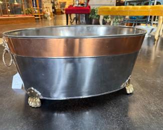 Vintage large oval beverage tub with decorative brass lion head handles and claw feet 