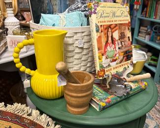 Green painted pedestal table, yellow pitcher and cook bookds