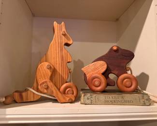 Vintage primitive kangaroo and frog wooden pull toys.