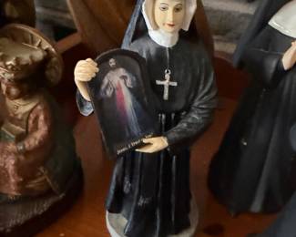 St. Faustina Kowalska statue featuring her holding the Divine Mercy image with the phrase "Jesus, I Trust in You"
