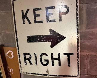 vintage, weathered "Keep Right" traffic sign with an arrow indicating right