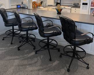 (4) black swivel bar stools with tufted upholstery and wheel base