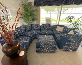 6 piece Coastal/Palm Beach Regency design modular sectional sofa with ottoman features vibrant navy blue fabric with a tropical leaf pattern