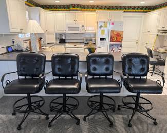 (4) black swivel bar stools with tufted upholstery and wheel base