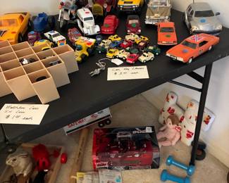 Lots of vintage toy cars and key chains with mini cars