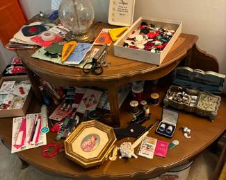 Sewing supplies on half circle tiered side table