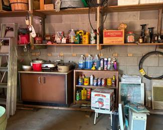 Automotive supplies, canned motor oil, kitchen items, shelves, jumper cables