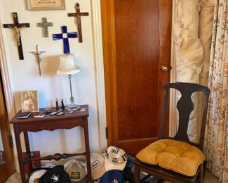 Side table with crucifixes, ball caps, 100 yr old rocker