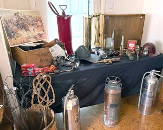 Vintage firefighting equipment: hose nozzles, extinguishers, helmet; fog horn