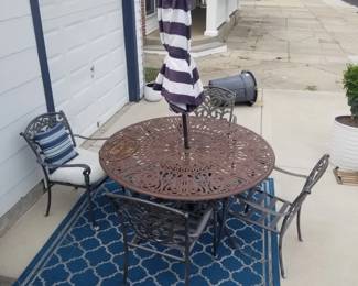 Patio dining set with umbrella; outdoor rug
