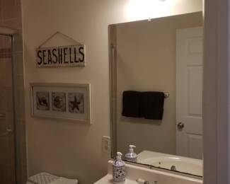 Vanity light; mirror; bath vanity. Artwork & seashore sentiments