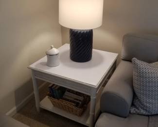 White end table; navy table lamp