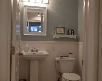 Pedestal sink; vanity lights; mirrored medicine cabinet; commode