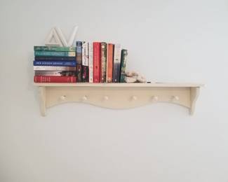Wall shelf with clothing pegs