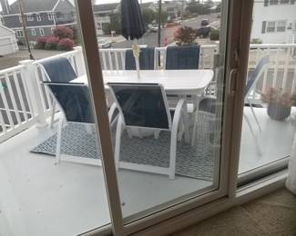 Patio dining set with umbrella seats 6; rug; potted plants