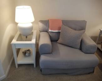 Glass top end table (two available); table lamp; oversized chair