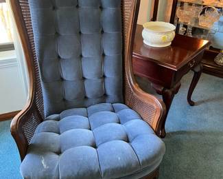 Here is the other matching blue chair, sitting in front of a small side table.