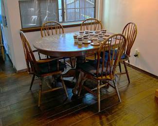 This picture shows the modest dining table and matching chairs.  Come check out the cups and saucers, too.