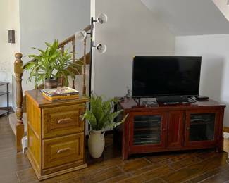 Here we have a two-drawer filing cabinet, an entertainment center, and video monitor.