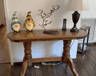 The couple of gnomes here are helping to guard this table, sculpture, and lamp.