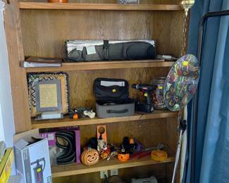 This bookcase has a number of miscellaneous items on it.  Come take a look at everything in person.