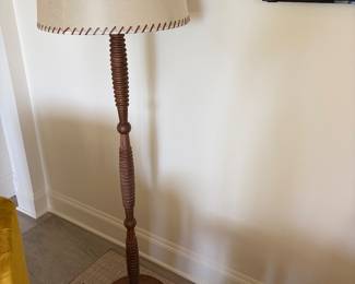 $460 Wood base floor lamp with parchment with leather whipstitching shade. 59"h X 17.5" diam.