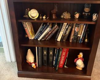 Small Bookcase With Books, Ducks, And Other Items